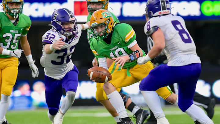 Brock Beaner, left, and Tyler Olson close in on a tackle during Anacortes' 60-30 win over Tumwater to win WIAA Class 2A title in 2023.