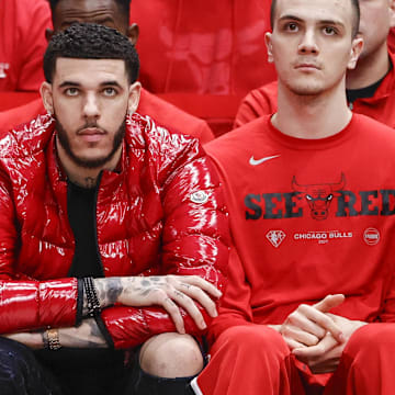 Apr 22, 2022; Chicago, Illinois, USA; Chicago Bulls guard Lonzo Ball (center) looks on from the bench during the second half of game three of the first round for the 2022 NBA playoffs against the Milwaukee Bucks at United Center. Mandatory Credit: Kamil Krzaczynski-Imagn Images