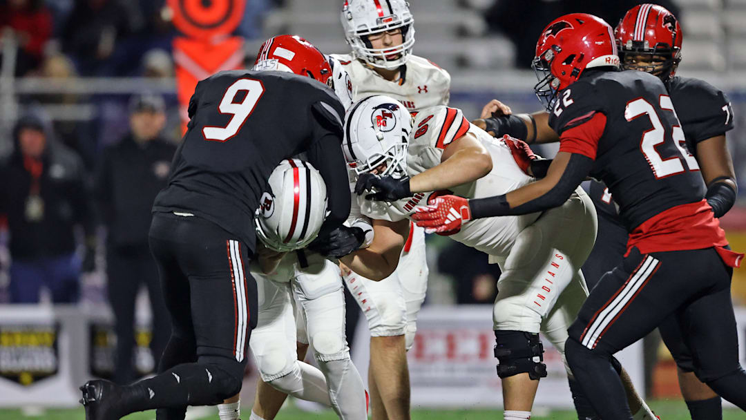 Zahir Mathis of Imhotep Charter (No. 9) makes a tackle against Peters Township in the 2023 PIAA Class 5A state championship gam.e 