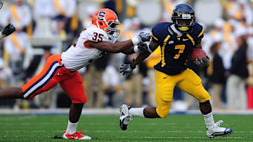Oct. 23, 2010; Morgantown, WV, USA; Syracuse Orange safety Michael Holmes (35) attempts to tackle West Virginia Mountaineers running back Noel Devine (7) during the first quarter at Mountaineer Field at Milan Puskar Stadium. Mandatory Credit: Andrew Weber-Imagn Images