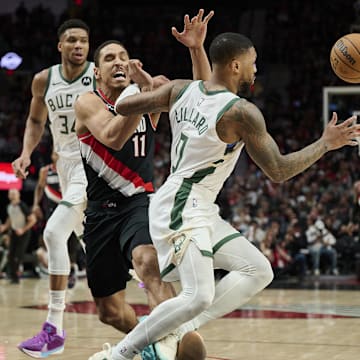 Jan 31, 2024; Portland, Oregon, USA; Milwaukee Bucks guard Damian Lillard (0) steals the ball away from Portland Trail Blazers guard Malcolm Brogdon (11) during the second half at Moda Center. Mandatory Credit: Troy Wayrynen-Imagn Images