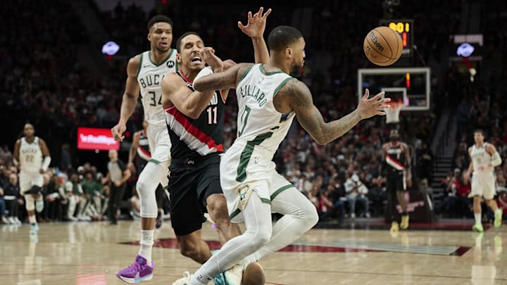 Jan 31, 2024; Portland, Oregon, USA; Milwaukee Bucks guard Damian Lillard (0) steals the ball away from Portland Trail Blazers guard Malcolm Brogdon (11) during the second half at Moda Center. Mandatory Credit: Troy Wayrynen-Imagn Images