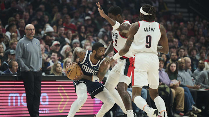 Dec 28, 2024; Portland, Oregon, USA; Dallas Mavericks guard Kyrie Irving (11) runs into a double team defense by Portland Trail Blazers center Deandre Ayton (2) and forward Jerami Grant (9) during the first half at Moda Center. Mandatory Credit: Troy Wayrynen-Imagn Images Dec 28, 2024; Portland, Oregon, USA; Dallas Mavericks guard Kyrie Irving (11) runs into a double team defense by Portland Trail Blazers center Deandre Ayton (2) and forward Jerami Grant (9) during the first half at Moda Center. Mandatory Credit: Troy Wayrynen-Imagn Images