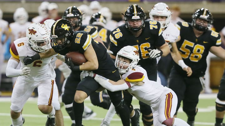 Ankeny tight end/linebacker Connor Kayser (6) and safety Dylan Dougherty (4) take down Southeast Polk running back Landon Vander Werff (22) during the third quarter in the class 5A Iowa High School football championship game at UNI Dome on Friday, Nov. 17, 2023, in Cedar Falls, Iowa.