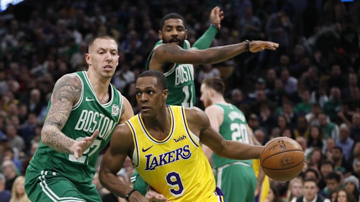 Los Angeles Lakers guard Rajon Rondo drives the ball against Boston Celtics guard Kyrie Irving and forward Daniel Theis Los Angeles Lakers guard Rajon Rondo drives the ball against Boston Celtics guard Kyrie Irving and forward Daniel Theis
