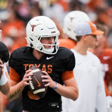 April 20, 2024; Austin, Texas, USA: Texas Longhorns quarterbacks Arch Manning (16), left, and  Quinn Ewers (3) throw passes while warming up ahead of the Longhorns' spring Orange and White game at Darrell K Royal Texas Memorial Stadium.