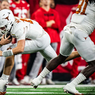 Texas Longhorns quarterback Arch Manning (16) carries the ball for a first down in the second quarter as the Texas Longhorns play the Ohio State Buckeyes in the Cotton Bowl College Football Playoff semi-final at AT&T Stadium in Dallas, Texas, Jan. 10, 2025.