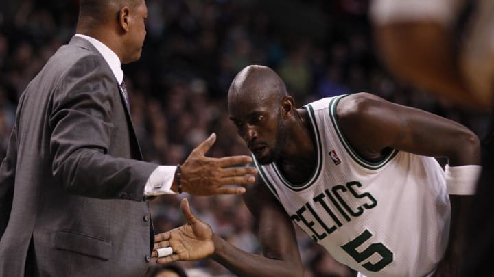 Feb 01, 2013; Boston, MA, USA; Boston Celtics power forward Kevin Garnett (5) and head coach Doc Rivers share a hand-shake during a break in the action against the Orlando Magic in the second half at the TD Garden. The Celtics defeated the Orlando Magic 97-84. Mandatory Credit: David Butler II-USA TODAY Sports