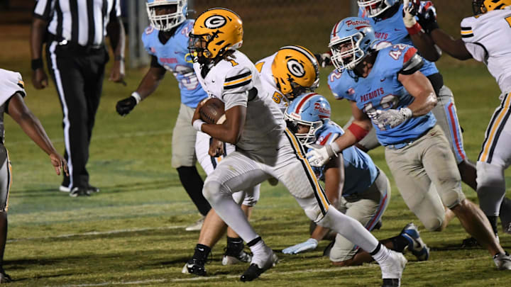 Greenwood High quarterback Triston Lewis (1) runs by JL Mann defender Wyatt Ward (42) for a touchdown during the fourth quarter at JL Mann High in Greenville, S.C. Tuesday, Oct 22, 2024. The Eagles entered the Top 25 South Carolina High School Football Rankings this week at No. 23. Greenwood High quarterback Triston Lewis (1) runs by JL Mann defender Wyatt Ward (42) for a touchdown during the fourth quarter at JL Mann High in Greenville, S.C. Tuesday, Oct 22, 2024. The Eagles entered the Top 25 South Carolina High School Football Rankings this week at No. 23.