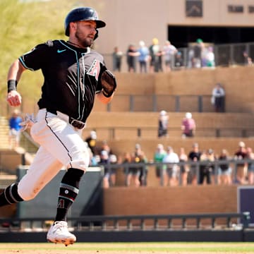 Arizona Diamondbacks 	Garrett Hampson scores on a Randal Grichuk single off Athletics starting pitcher Joey Estes in the second inning during a spring training game at Salt River Fields in Scottsdale on March 20, 2025.