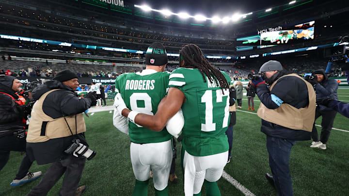 New York Jets quarterback Aaron Rodgers (8) and wide receiver Davante Adams (17) walk on the field after the Jets win