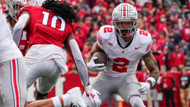 Wide receiver runs with the football after a catch.