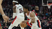 Jan 16, 2025; Portland, Oregon, USA; Portland Trail Blazers guard Scoot Henderson (00) dribbles around center Robert Williams III (35) during the second half against LA Clippers guard James Harden (1) at Moda Center. Mandatory Credit: Troy Wayrynen-Imagn Images