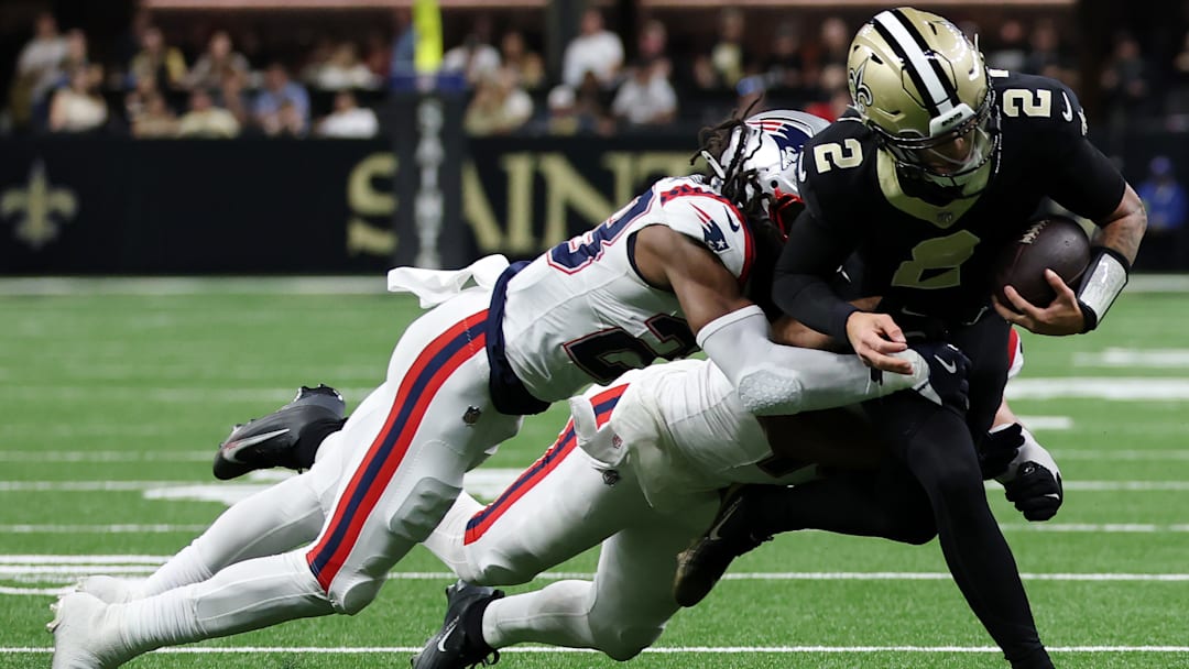 New Orleans Saints QB Spencer Rattler (2) is pursued by New England Patriots Safety Kyle Duggar (22) and Linebacker Robert Spillane (14) on Oct. 12, 2025.