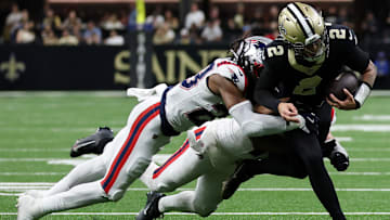 New Orleans Saints QB Spencer Rattler (2) is pursued by New England Patriots Safety Kyle Duggar (22) and Linebacker Robert Spillane (14) on Oct. 12, 2025.
