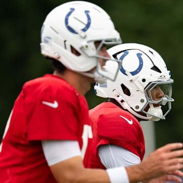 Indianapolis Colts quarterbacks Anthony Richardson Sr. (5) and Daniel Jones (17) drop back to pass Monday, July 28, 2025, during training camp held at Grand Park in Westfield.