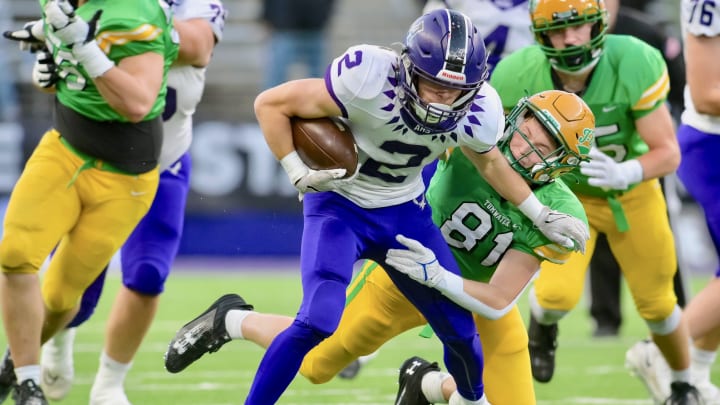Anacortes wide receiver Brady Beaner pulls away from a defender in WIAA Class 2A championship game.