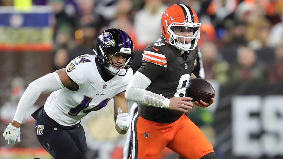 Cleveland Browns quarterback Dillon Gabriel (8) runs to the sideline away from Baltimore Ravens safety Kyle Hamilton (14) during the first half of an NFL football game at Huntington Bank Field, Nov. 16, 2025, in Cleveland, Ohio.