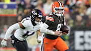 Cleveland Browns quarterback Dillon Gabriel (8) runs to the sideline away from Baltimore Ravens safety Kyle Hamilton (14) during the first half of an NFL football game at Huntington Bank Field, Nov. 16, 2025, in Cleveland, Ohio.