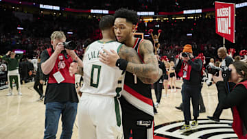 Jan 31, 2024; Portland, Oregon, USA; Portland Trail Blazers guard Anfernee Simons (1) embraces Milwaukee Bucks guard Damian Lillard (0) after a game at Moda Center. Mandatory Credit: Troy Wayrynen-Imagn Images