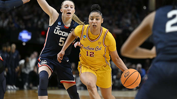 Apr 1, 2024; Portland, OR, USA; USC Trojans guard JuJu Watkins (12) drives to the basket during the second half against UConn Huskies guard Paige Bueckers (5) in the finals of the Portland Regional of the NCAA Tournament at the Moda Center. Mandatory Credit: Troy Wayrynen-Imagn Images