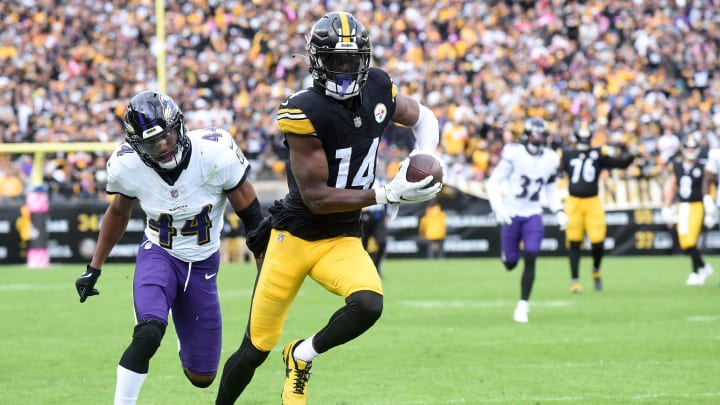 Oct 8, 2023; Pittsburgh, Pennsylvania, USA;  Pittsburgh Steelers wide receiver George Pickens (14) catches a 41 yard pass for a touchdown as Baltimore Ravens cornerback Marion Humphrey (44) applies coverage during the fourth quarter at Acrisure Stadium. The catch was the game-winning score as the Steelers won 17-10.  Mandatory Credit: Philip G. Pavely-USA TODAY Sports