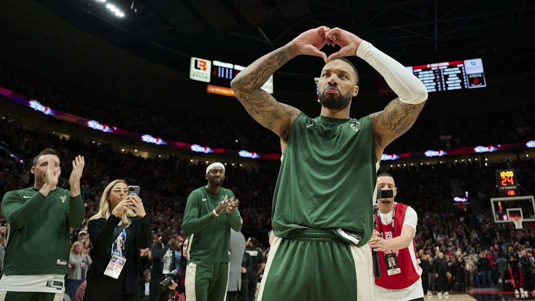 Milwaukee Bucks guard Damian Lillard (0) shows his love for Portland fans during introductions before a game against the Portland Trail Blazers at Moda Center. 