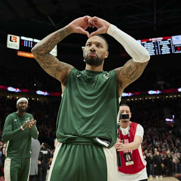 Milwaukee Bucks guard Damian Lillard (0) shows his love for Portland fans during introductions before a game against the Portland Trail Blazers at Moda Center. 