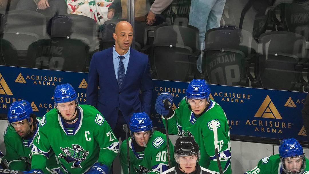 Abbotsford head coach Manny Malhotra watches his team from the bench during the first period of their game at Acrisure Arena in Palm Desert, Calif., Wednesday, Jan. 29, 2025.