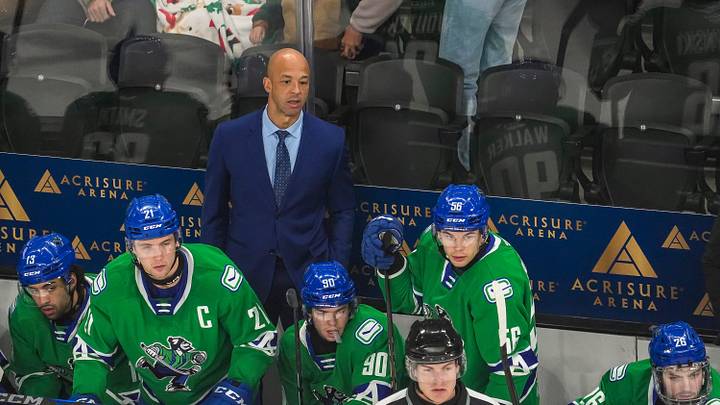 Abbotsford head coach Manny Malhotra watches his team from the bench during the first period of their game at Acrisure Arena in Palm Desert, Calif., Wednesday, Jan. 29, 2025.