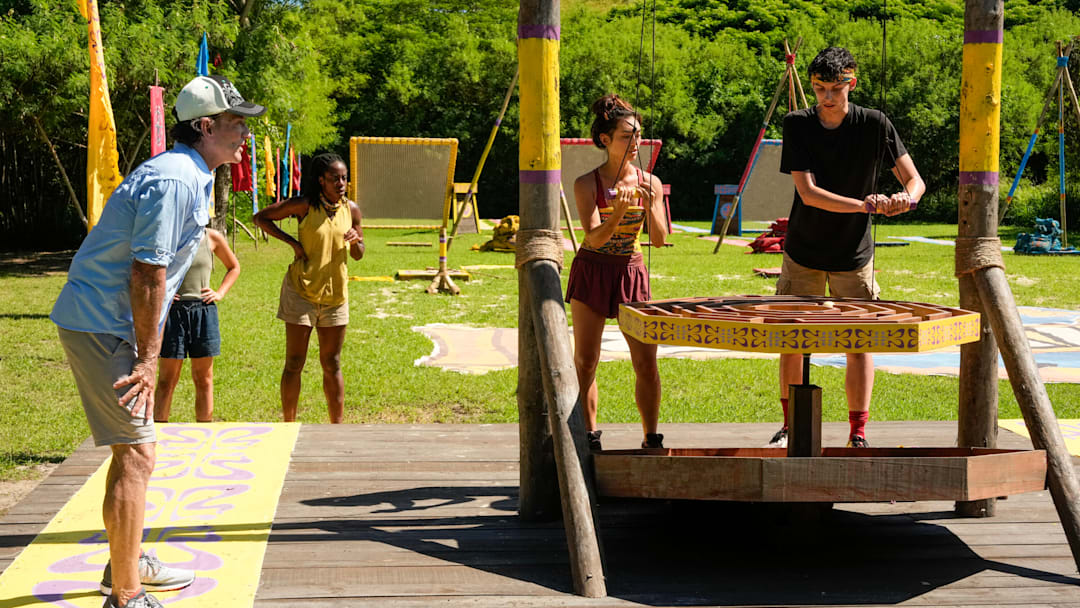“The Devil’s Shoes” – A major shakeup hits the game when two tribes turn to three. New tribe members size each other up, but with only four players on each tribe, there is not much room to hide. Then, heat and exhaustion take a major toll on one castaway, on SURVIVOR, Wednesday, Oct. 29. Pictured (L-R): Jeff Probst, Savannah Louie, and Rizo Velovic. Photo: Robert Voets/CBS ©2025 CBS Broadcasting, Inc. All Rights Reserved.