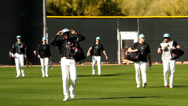 Arizona Diamondbacks outfielder Kristian Robinson adjusts his cap during spring training workouts at