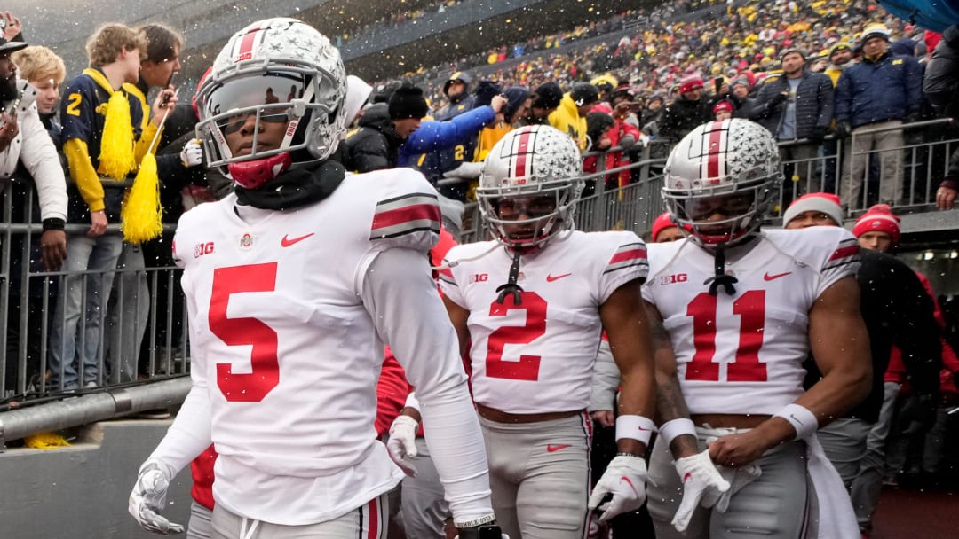 Ohio State Buckeyes wide receivers Garrett Wilson (5), Chris Olave (2) and Jaxon Smith-Njigba (11) take the the field for the NCAA football game against the Michigan Wolverines at Michigan Stadium in Ann Arbor on Sunday, Nov. 28, 2021.

Ohio State Buckeyes At Michigan Wolverines