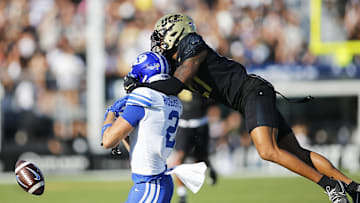 Oct 26, 2024; Orlando, Florida, USA;  Central Florida Knights cornerback Chasen Johnson (27) is flagged for pass interference against Brigham Young Cougars wide receiver Chase Roberts (2) in the first half at FBC Mortgage Stadium. Mandatory Credit: Russell Lansford-Imagn Images