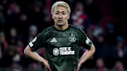 Celtic forward Daizen Maeda stands on the pitch during UCL second leg knock-out playoff match against Bayern Munich. 