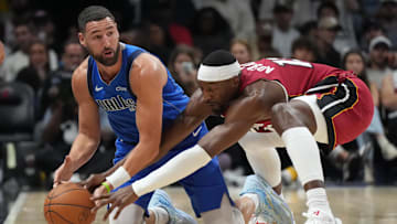 Nov 24, 2025; Miami, Florida, USA; Dallas Mavericks guard Klay Thompson (31) and Miami Heat center Bam Adebayo (13) battle for a loose ball during the second half at Kaseya Center. Mandatory Credit: Jim Rassol-Imagn Images