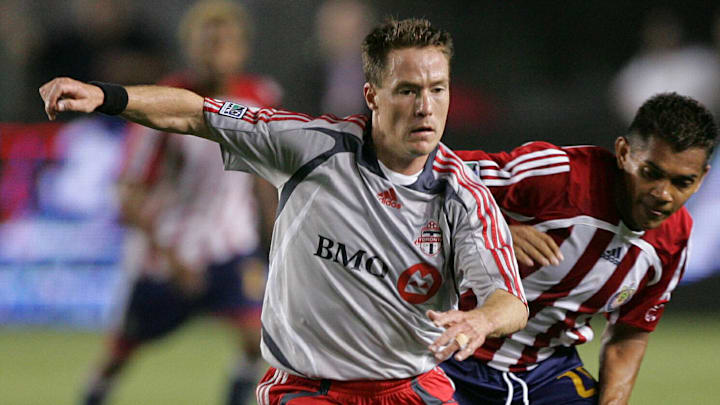 TFC midfielder Richard Mulrooney is shadowed by Chiva's Amado Guevara in Toronto's first ever match on 7 April 2007.