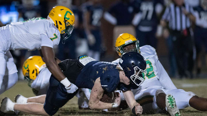 Quarterback Wells Bettenhausen (1) is sacked during the Catholic vs Walton high school playoff football game at Walton HIgh School in DeFuniak Springs on Friday, Nov. 17, 2023.
