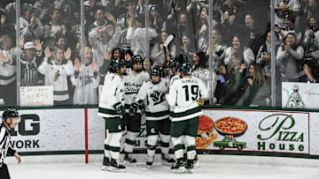 Hockey fans and MSU hockey players celebrate Matt Basgall's goal against Notre Dame, Saturday, Nov. 15, 2024, at Munn Ice Arena. MSU won 4-3 to sweep the series.