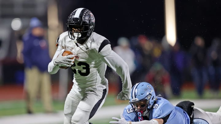 Aliquippa running back Tiqwai Hayes runs away from a Dallas defender in the 2023 PIAA Class 4A state championship game. 