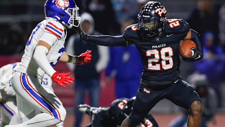 Pittsburg RB/SS Jamar Searcy (28) offers a stiff arm during the Pirates' 28-27 win over Folsom for the CIF Division 1-AA Northern California Regional title on Friday. At Pittsburg High School, 12-6-2024 Pittsburg RB/SS Jamar Searcy (28) offers a stiff arm during the Pirates' 28-27 win over Folsom for the CIF Division 1-AA Northern California Regional title on Friday. At Pittsburg High School, 12-6-2024