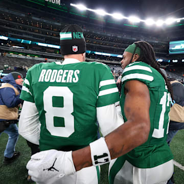Jan 5, 2025; East Rutherford, New Jersey, USA; New York Jets quarterback Aaron Rodgers (8) and wide receiver Davante Adams (17) walk on the field after the Jets win over the Miami Dolphins at MetLife Stadium. Mandatory Credit: Ed Mulholland-Imagn Images
