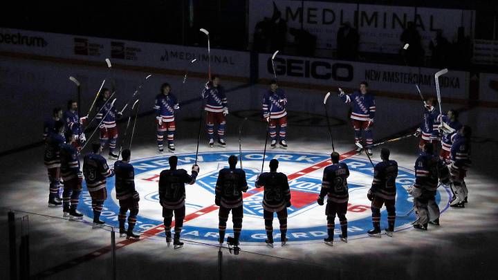Jan 14, 2021; New York, NY, USA;  New York Rangers players huddle around the center ice logo as they prepare for the home opener against the New York Islanders at Madison Square Garden.  