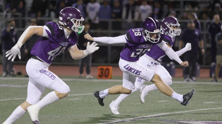 Carlsbad's Tyler Prasuhn kicks off in last season's Open Division playoffs