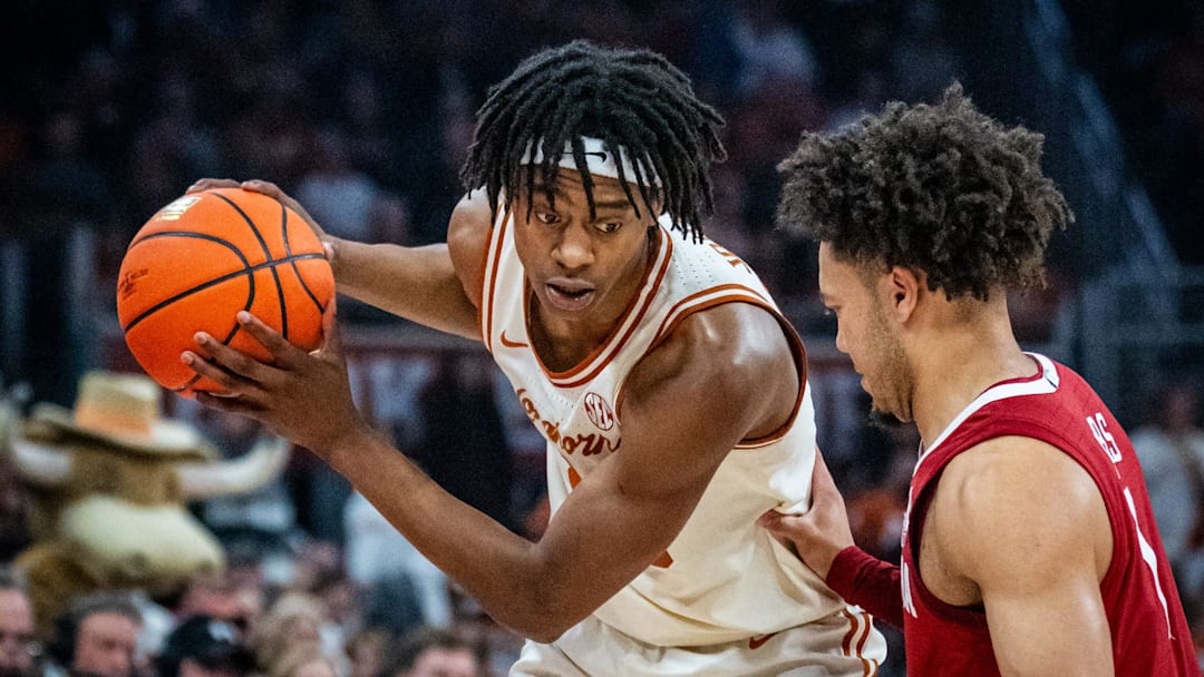 Texas Longhorns guard Tre Johnson (20) looks for an opening as Alabama Crimson Tide guard Mark Sears (1) defends in the first half as the Texas Longhorns take on the Crimson Tide at the Moody Center, Feb. 11, 2025. Texas Longhorns guard Tre Johnson (20) looks for an opening as Alabama Crimson Tide guard Mark Sears (1) defends in the first half as the Texas Longhorns take on the Crimson Tide at the Moody Center, Feb. 11, 2025.