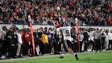 Razorback freshman Dazmin James goes up for a catch over Texas Tech senior defensive back C.J. Baskerville during Friday's 39-26 Arkansas victory in the 2024 Liberty Bowl in Memphis.