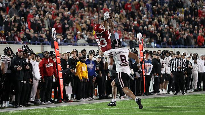 Razorback freshman Dazmin James goes up for a catch over Texas Tech senior defensive back C.J. Baskerville during Friday's 39-26 Arkansas victory in the 2024 Liberty Bowl in Memphis.