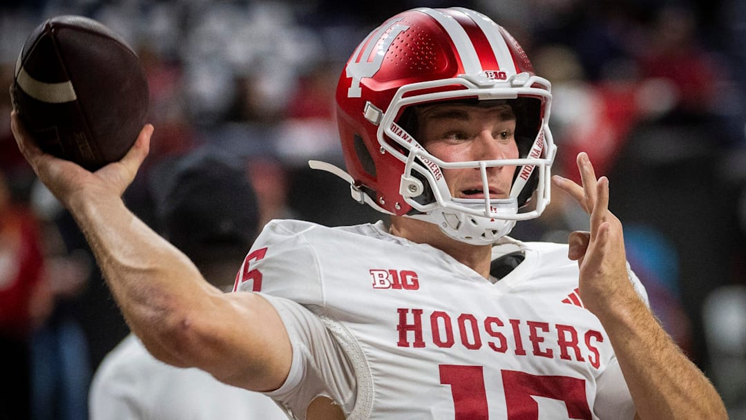 Indiana's Fernando Mendoza (15) gets loose before the Indiana versus Ohio State Big Ten Championship football game at Lucas Oil Stadium on Saturday, Dec. 6, 2025.