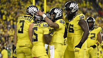 Oct 4, 2024; Eugene, Oregon, USA; Oregon Ducks wide receiver Tez Johnson (15), left, celebrates catching a touchdown pass with Oregon Ducks quarterback Dillon Gabriel (8) during the second half against the Michigan State Spartans at Autzen Stadium. Mandatory Credit: Troy Wayrynen-Imagn Images