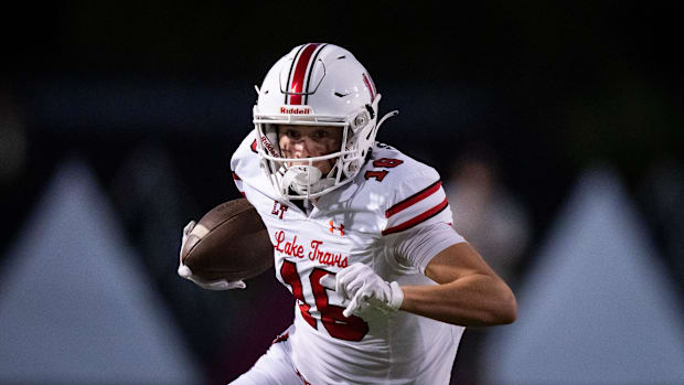 Lake Travis' Patrick Colby (16) carries the ball at Burger Stadium in a win over Bowie on Sept. 27, 2024.